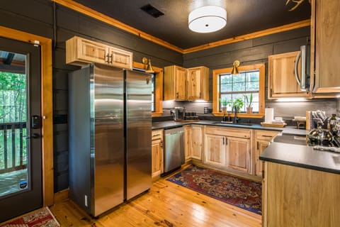 Entry door is located between the kitchen and dining area.