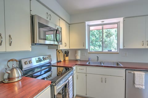 Well equipped kitchen with new appliances and backyard views