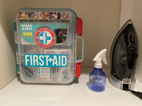 FIRST AID KIT, IRON & IRONING BOARD in the Master Bedroom closet