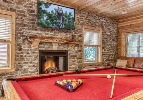 Gameroom on bottom floor with pool table, arcade, and flatscreen