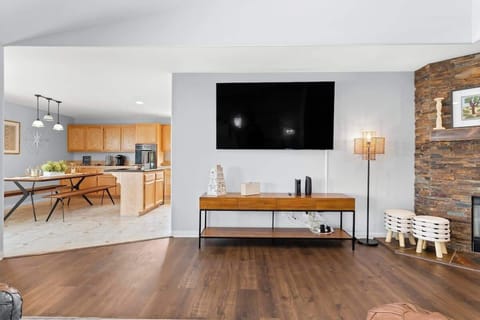 Indulge in the comfort and tranquility of this contemporary house. The space features an open-concept layout, a monochromatic color scheme with stark contrasts, wood surfaces, and tasteful furnishings and decor.