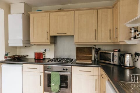 Kitchen with amenities such as an oven, microwave, kettle & toaster