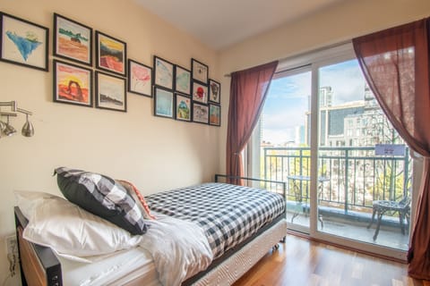 Second bedroom with comfortable twin trundle beds, cozy balcony w/ city views