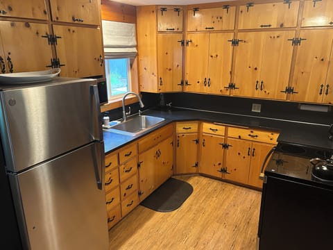 Knotty pine kitchen stocked with new appliances to meet all your cooking needs. 