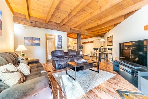 Cozy living area with flat screen TV, gas fireplace, ample seating and access to the private back deck.