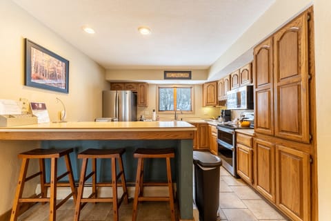 Full-size kitchen with updated stainless steel appliances.