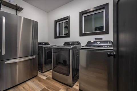 Laundry room with full size washer/dryer and extra fridge/freezer