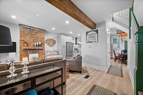 A view of the front door looking into the dining, kitchen and living room area. The first floor powder room is located in the center area where the door is pictured.