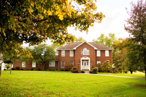 Beautiful front view of home, featuring a paved circle drive.