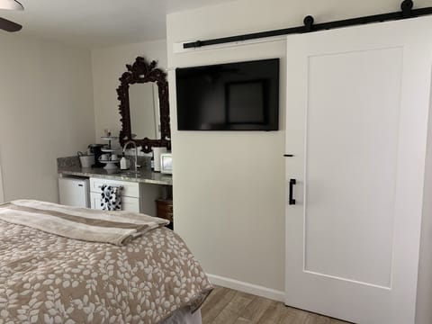 Queen bedroom suite, smart TV,  kitchenette, bathroom behind barn door.