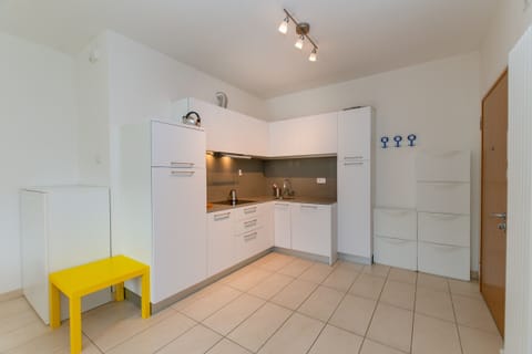 The kitchen equipped with dishwasher, stove and microwave