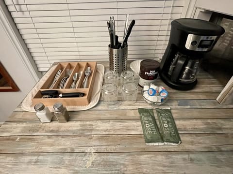 Silverware, kitchen utensils, coffee pot and a few coffee supplies 