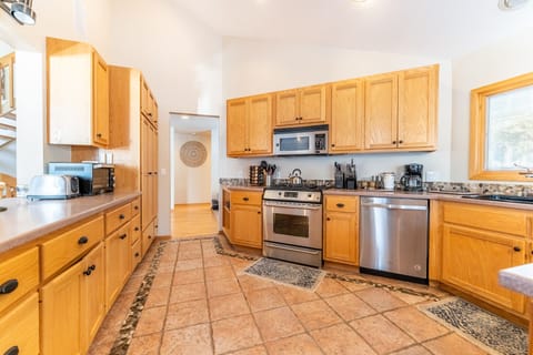 Updated full size kitchen with stainless steel appliances and vaulted ceilings.