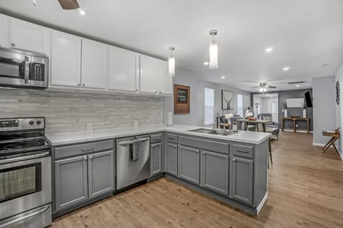 A kitchen with plenty of workspace and equipment.