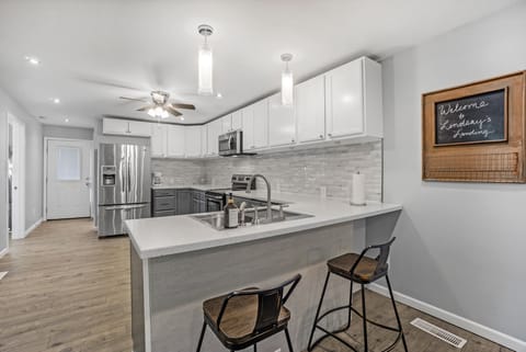 A kitchen with plenty of workspace and equipment.