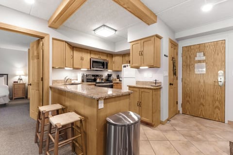 Step into your home-away-from-home kitchen where warm wood cabinets and granite counters invite you to whip up your favorite meals. The breakfast bar is perfect for your morning coffee ritual.