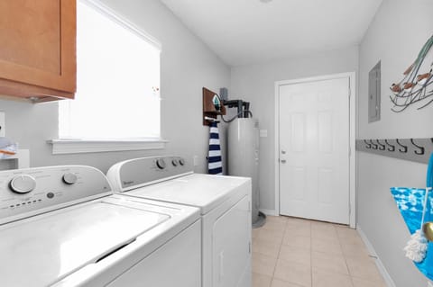 Laundry Room with full size washer and dryer, and iron and ironing board