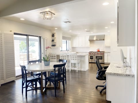 Informal dining/game table plus business center next to the kitchen.