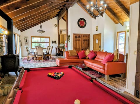 Wonderful open living area with pool table. leather sectional, gas stove /TV all facing the views.