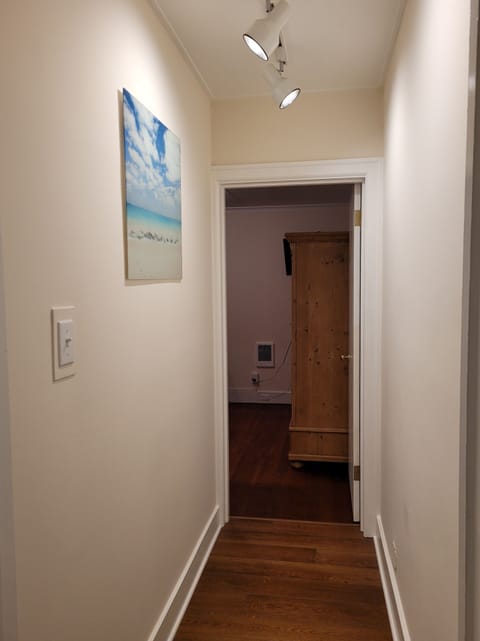 Private hall to bedroom #2 - Sand Room. Queen bed with 32-inch smart TV