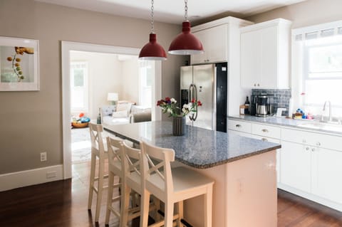 Kitchen with island seating is well-stocked with cookware and appliances.