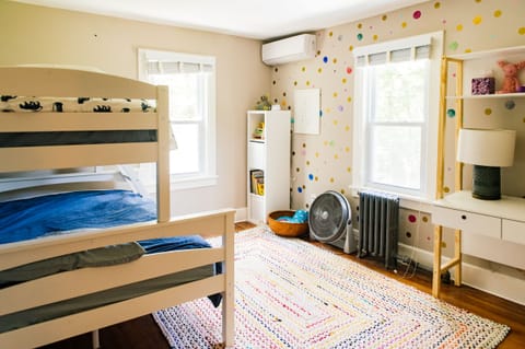 Kids' bedroom with full-size bunk bed and desk