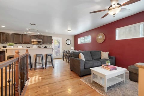 Take in the open-concept design of the main floor, featuring a spacious kitchen and comfortable sofas for lounging.