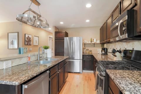 Our fully stocked kitchen is equipped with sleek stainless steel appliances and everything you need to whip up a delicious meal.