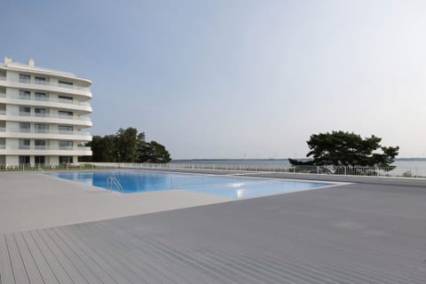 A stunning infinity pool overlooking a serene coastal landscape, perfect for relaxation.