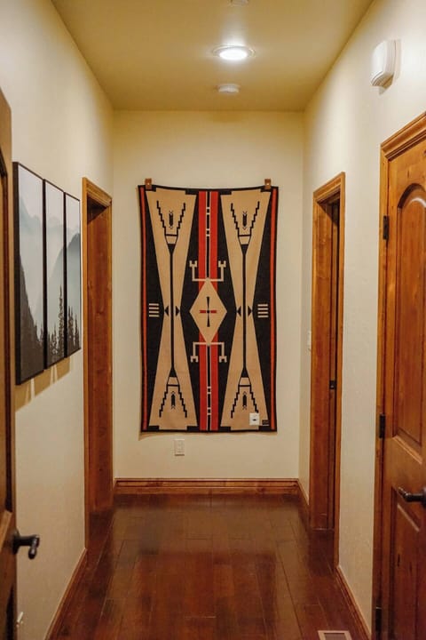 Pendleton Woolen Mills tapestry decorates the end of the hall where the downstairs bedroom and guest half-bath is located