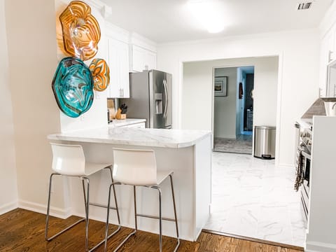 Large kitchen with gas stove, refrigerator, microwave, Keurig, toaster