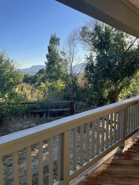 View of Cheyenne Mountain from covered porch and large fenced in yard