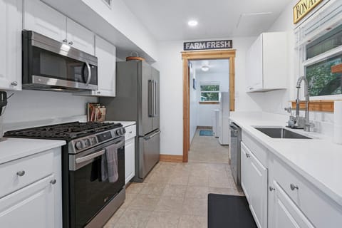 Full kitchen with refrigerator, oven, coffee maker, and microwave