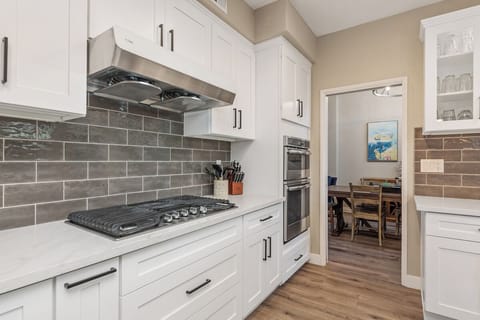 Fully renovated kitchen with stainless steel appliances, oversized island..