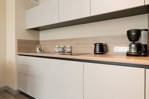 A closer look at the kitchen, showcasing the appliances, utensils, and countertop design.