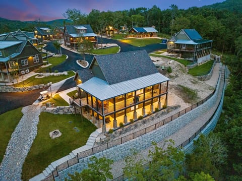 Cabin #2 far right nestled next to the forest and waterfall