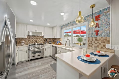 Impress your guests in this stylish kitchen featuring elegant bar seating.
