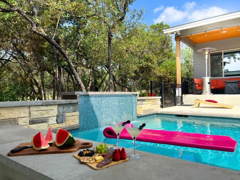 Welcome to Lago Vista Vibe - a spectacular Lake Travis acreage home with top amenities.  Swim up to the pool bar for some refreshments.
