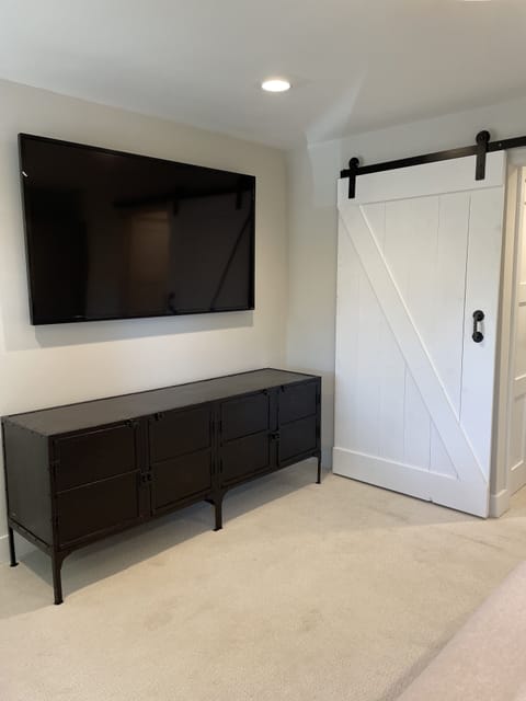 Barn doors and media unit in master bedroom