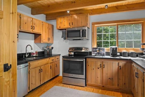 Beautiful kitchen with stainless steel stove, refrigerator, dishwasher, and awesome black soap stone counter tops.
