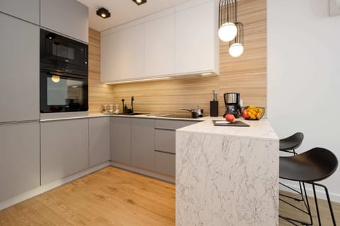 Another view of the kitchenette showing the built-in oven and microwave. The overall décor creates a cohesive whole with the rest of the flat.