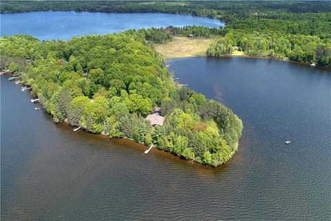 this house is on the end of the peninsula with a dock on the bay side and a dock on the main lake side