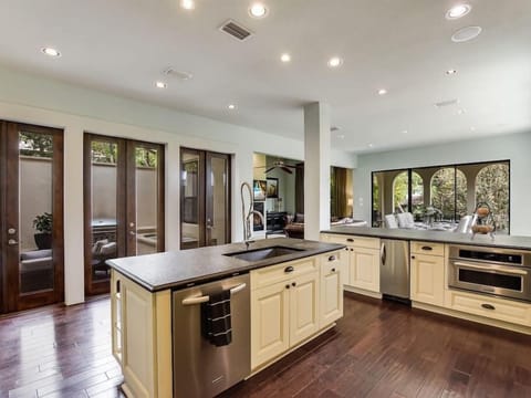 The pro-grade Kitchen looks out to the enclosed courtyard and spa as well as the first level open floor plan