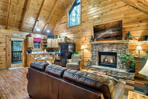 Kitchen and living room with large TV and gas fireplace