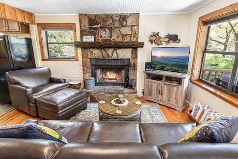 Cozy living room with wood burning fireplace, TV, high speed Wi-Fi, and cable