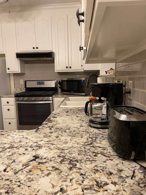 Kitchen is well stocked with utensils, plates, amenities, appliances to use