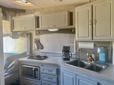 Small kitchen with double sink, fridge/freezer, stove burner and microwave!