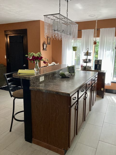 Kitchen island with prep space and raised top for four bar stools