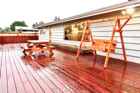 Entertaining deck with swing and picnic table