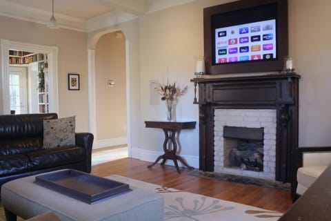 Raise or lower the remote-controlled mantel painting to watch TV.
